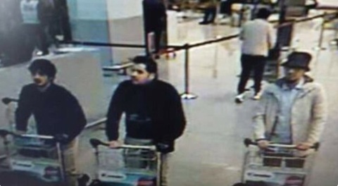 Belgian police release CCTV image of airport bombing suspects. Two men on left believed to be suicide bombers. Man in hat on right believed to be at large. Image: Brussels Police